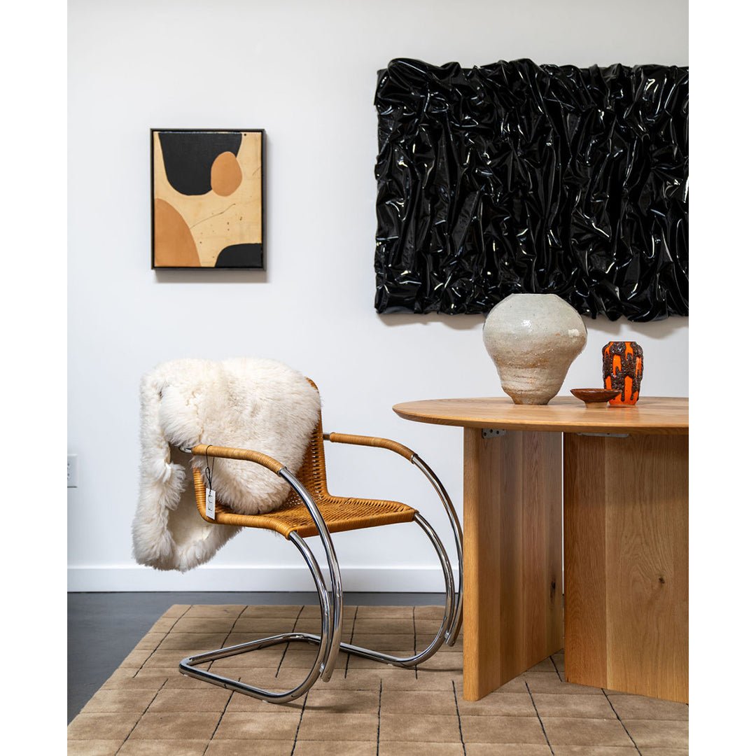 Jason Adkins art piece styled with vintage chair and table.
