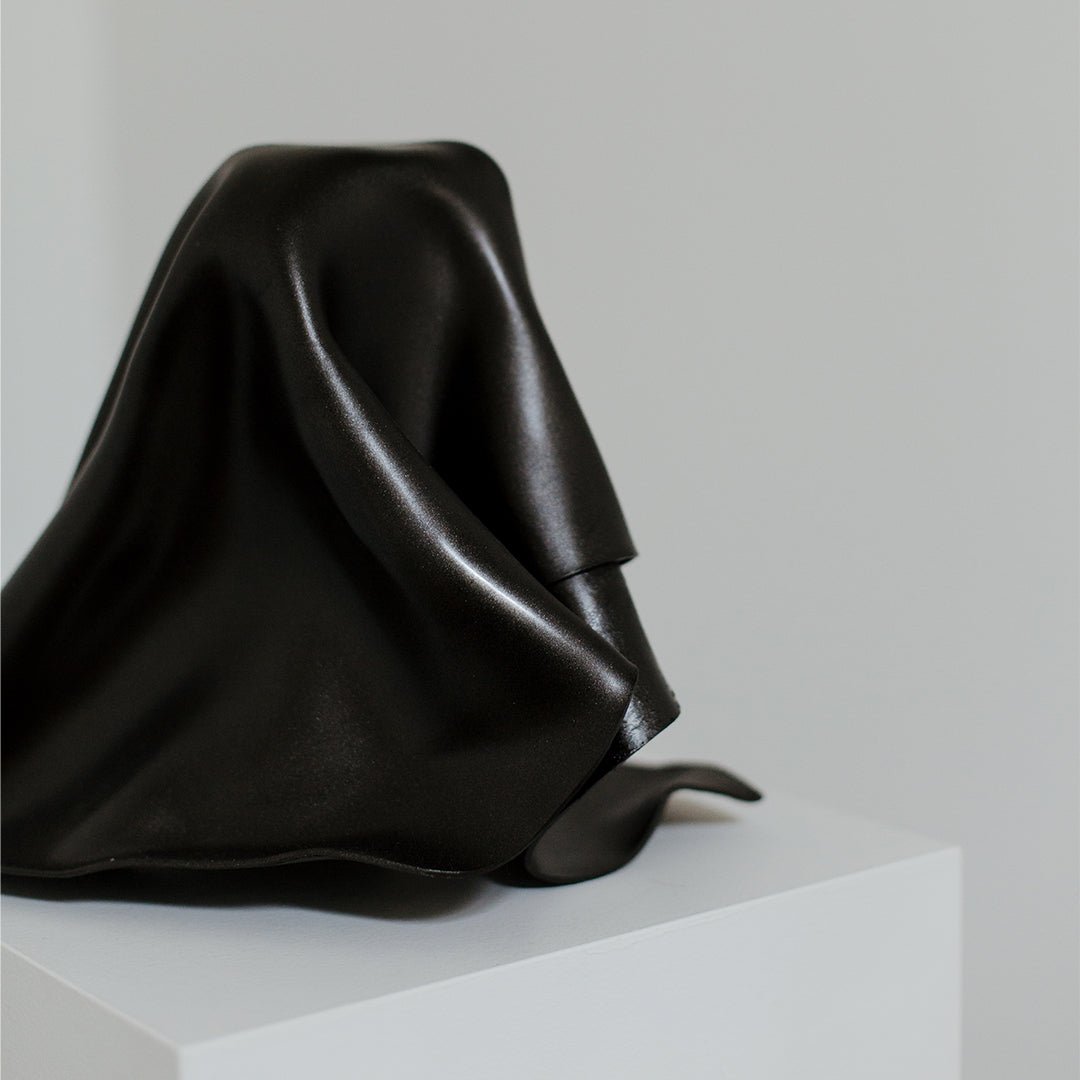 Close up of black fold sculpture showing molded acrylic sheet.