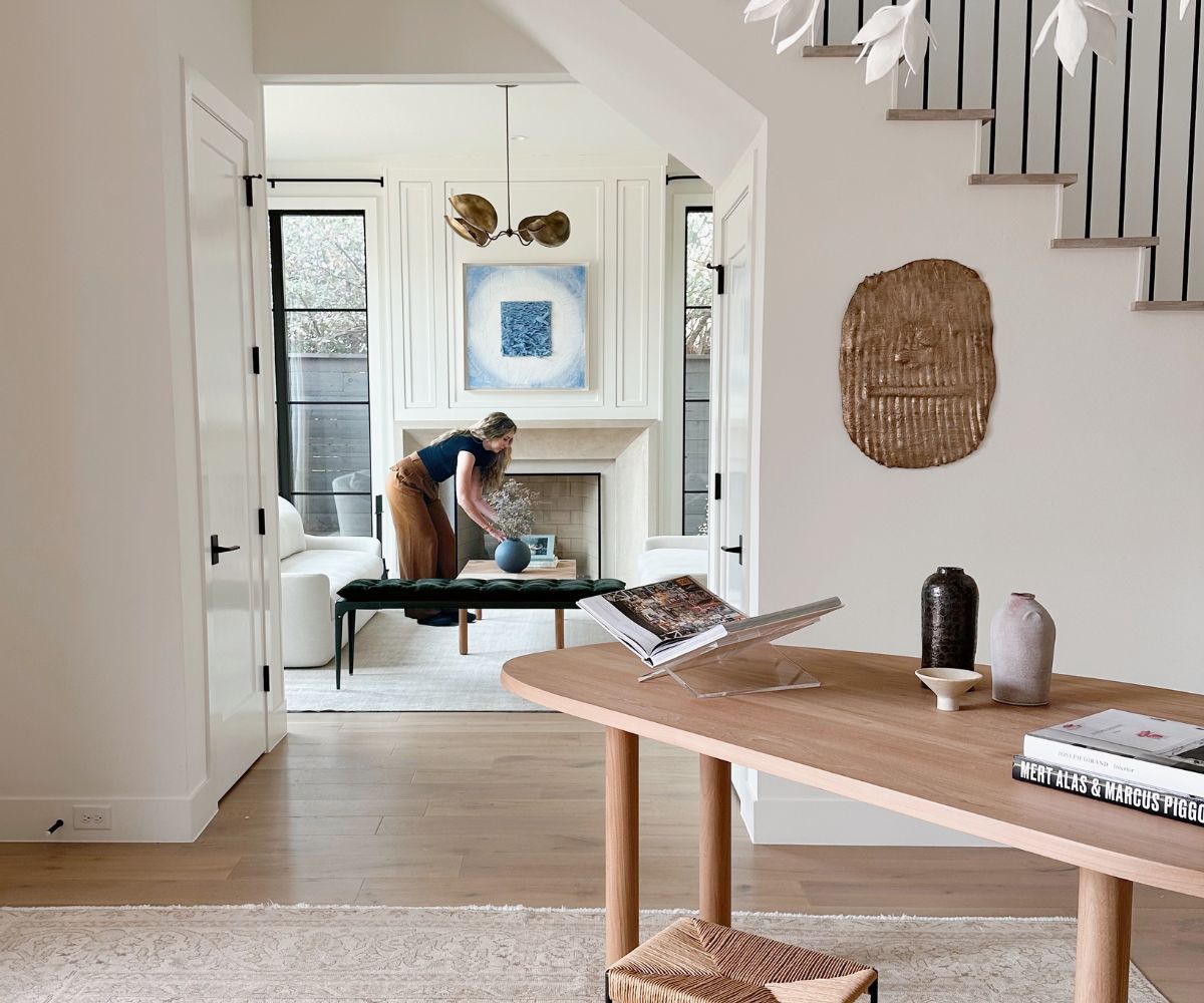 Woman styling interior for beautiful home in Dallas.